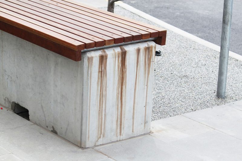 Leaked timber tannin stains on a concrete bench